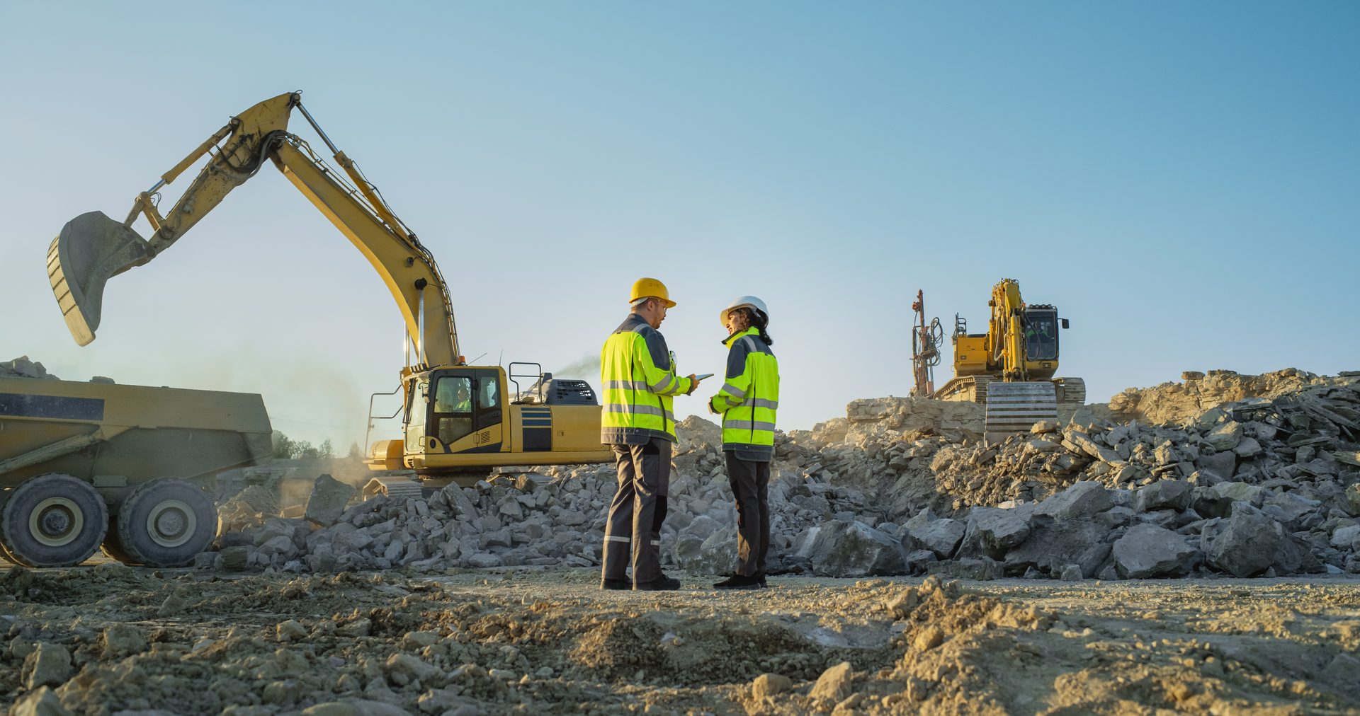 Earthmoving Excavators and Machinery at Dusk